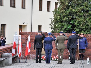 podczas uroczystości stoją obok siebie przedstawiciele służb mundurowych, oddają honor pod Pomnikiem Powstańców Śląskich